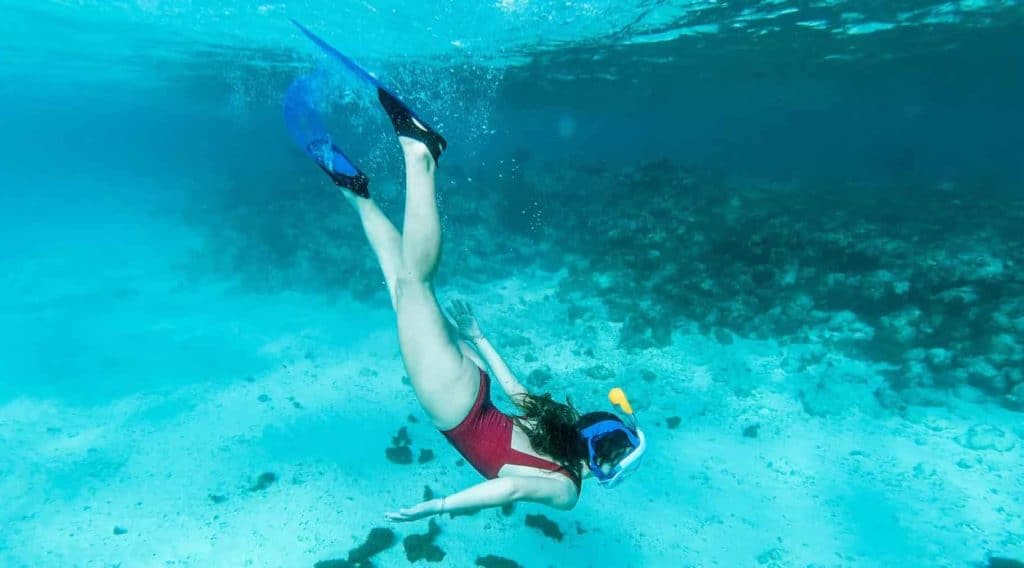 a girl snorkeling underwater