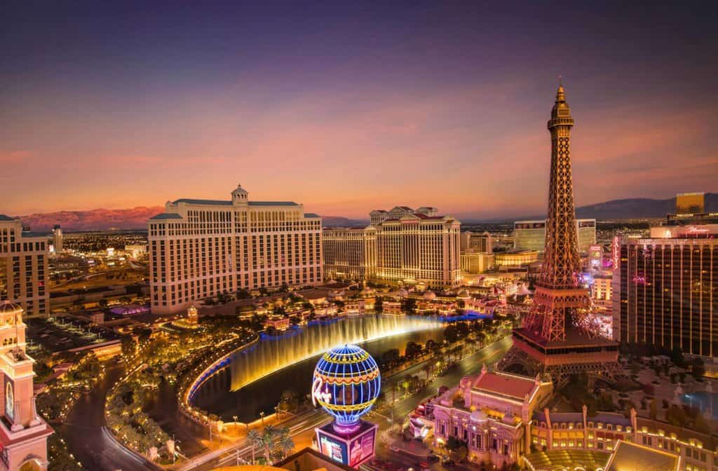 the Las Vegas Hotel of Paris and Bellagio during sunset with the fountain show for .A blog post talking bout all the best tips to know for people visiting Las Vegas for the first time.