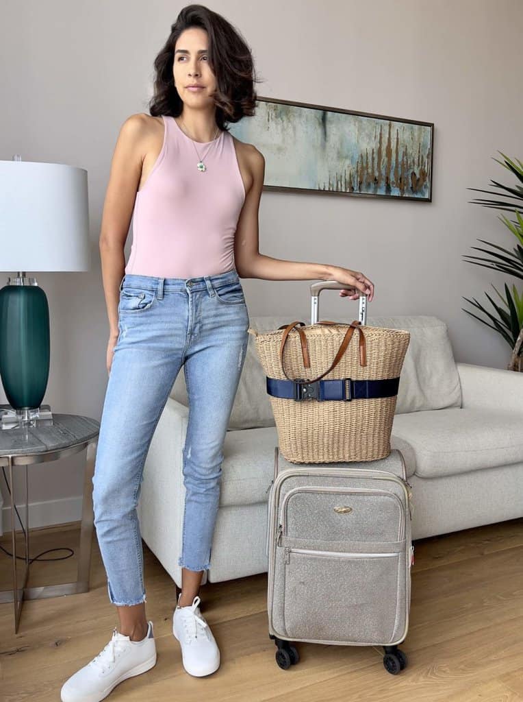 travel blogger posing with luggage and cincha travel belt