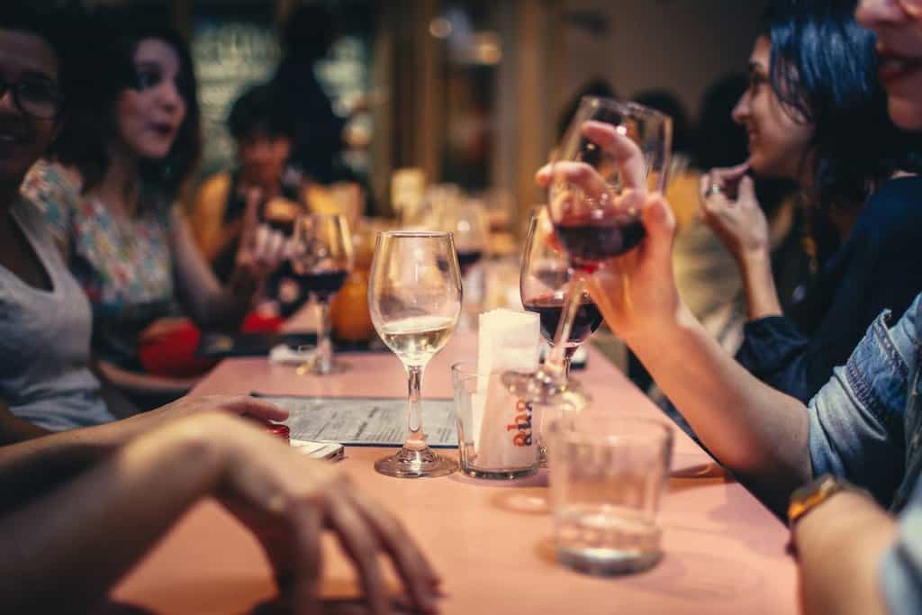 People enjoy dinner and drinking wine at a las vegas restaurant where local like to go outside of Las Vegas Strip