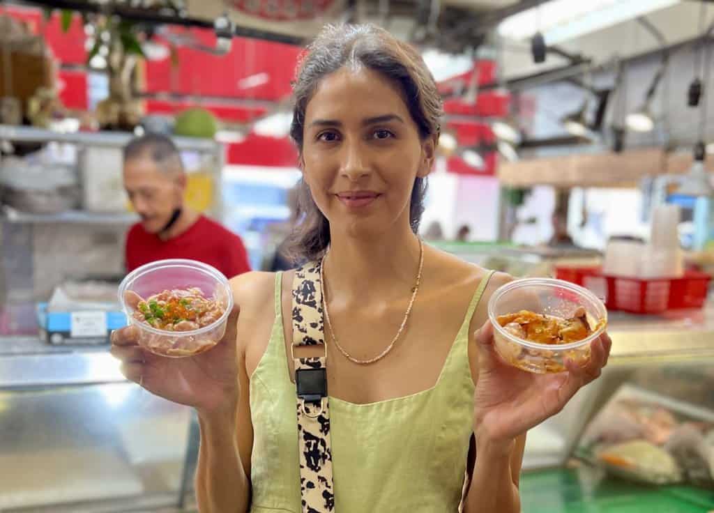 bridget during food tour in china town trying out fresh local poke.