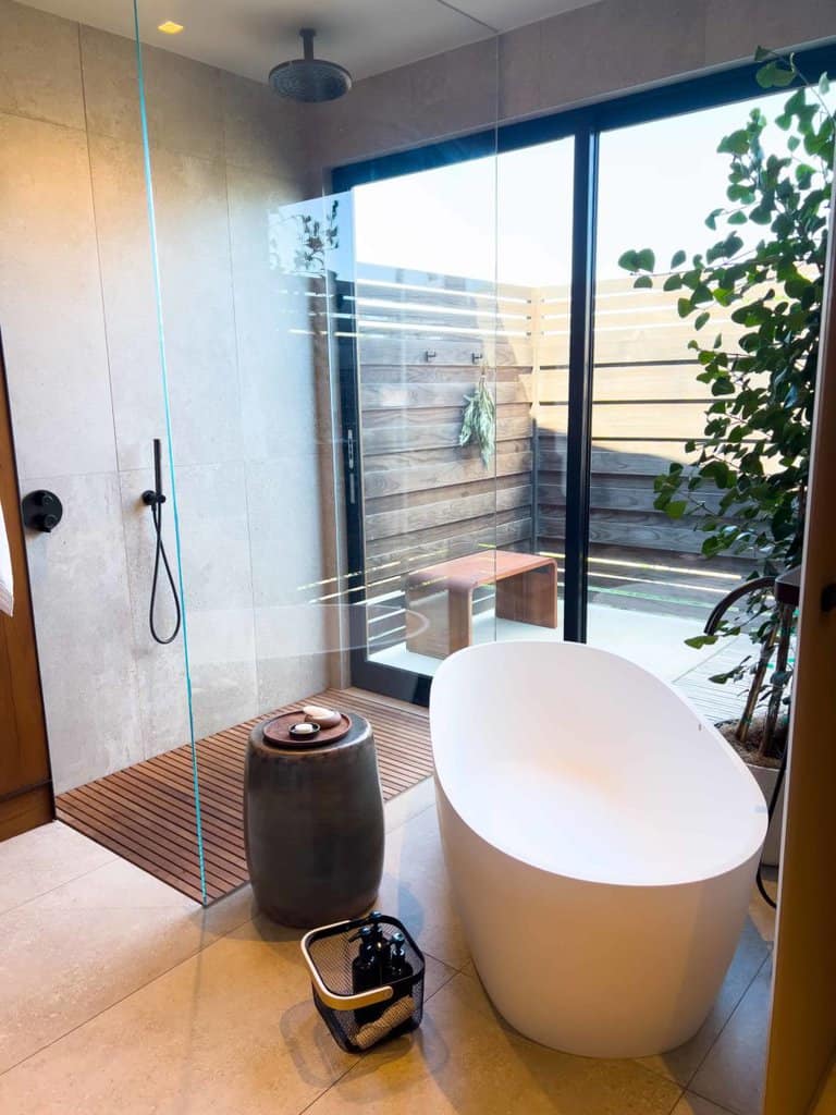 shower and bathtub in the room with outdoor shower too